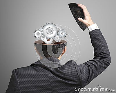 Working metal gears inside businessman's head Stock Photo