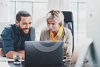 Working moments. Group of young coworkers people in casual wear discussing business ideas while working in the office. Stock Photo