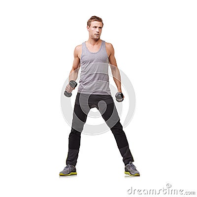 Working out with 4kg dumbbells. Full-body of a fit young man working out with dumbbells on a white background. Stock Photo