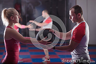 Working out in pairs, working out in the gym with personal trainer. Helping with loosing weight,training in pairs Stock Photo