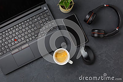 Working place and office desk with coffee, laptop, headset and smartphone Stock Photo