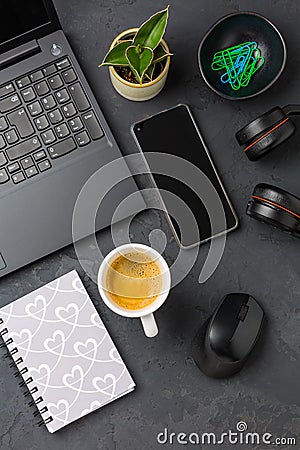 Working place and office desk with coffee, laptop, headset and smartphone Stock Photo