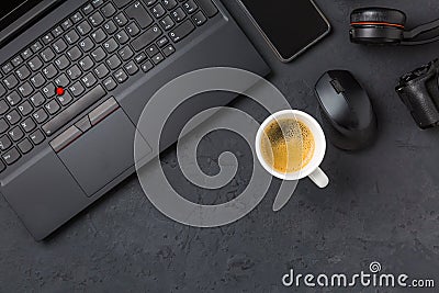 Working place and office desk with coffee, laptop, headset and smartphone Stock Photo