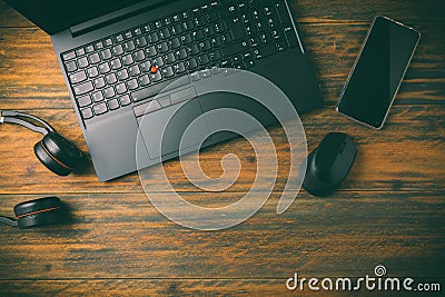 Working place and office desk with laptop, headset, smartphone and computer mouse Stock Photo