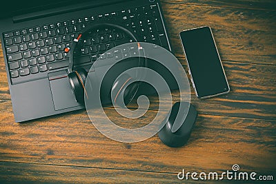 Working place and office desk with laptop, headset, smartphone and computer mouse Stock Photo