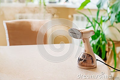 Working portable hand steamer for clothes. steam for ironing clothes. Stock Photo