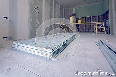 Working process of installing metal frames and plasterboard drywall and materials in apartment is under construction Stock Photo