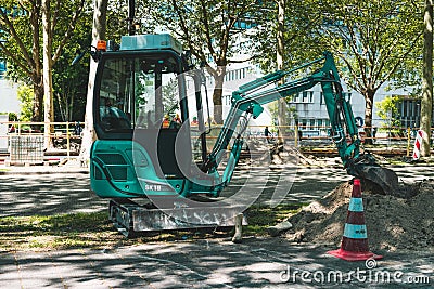 Mini excavator, Working on the road. Amsterdam Buitenveldert Editorial Stock Photo