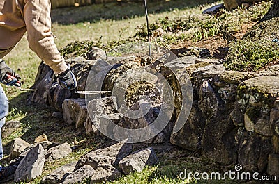 Working on a rock wall Stock Photo