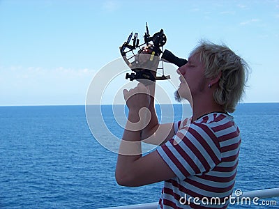 Working with sextant on board of merchant ship at noon time Stock Photo