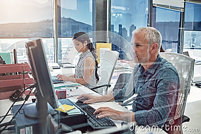 Working side by side. two colleagues working in the office. Stock Photo