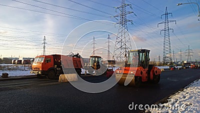 Working special technique during laying fresh asphalt on the main street Stock Photo