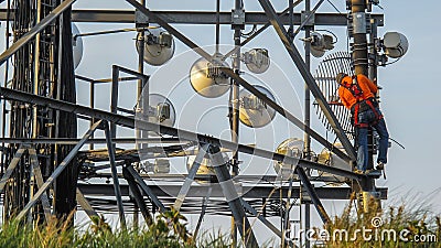 Working Technician up a telecommunications tower Stock Photo