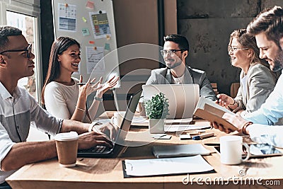 Working together. Group of young modern people in smart casual w Stock Photo