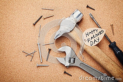 Working tools and note for Happy Fathers Day, cork board background, top view Stock Photo