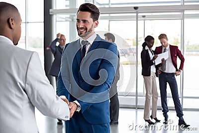 Workman heartily welcome black man Stock Photo