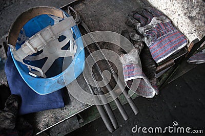 Workman helmet glove and tools Stock Photo