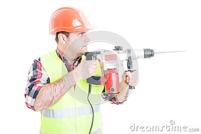 Workman with helmet holding the drilling machine Stock Photo