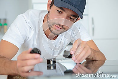 Workman holding black objects Stock Photo