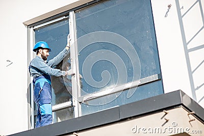 Workman mounting window Stock Photo
