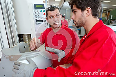 workman training apprentice in factory Stock Photo