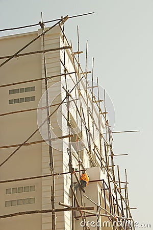 Workman on wooden scaffolding Stock Photo