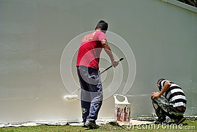 Workmen painting wall Editorial Stock Photo