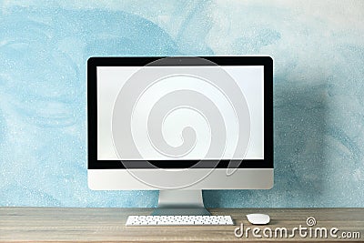 Workplace. Computer with empty screen on table. Light blue background Stock Photo