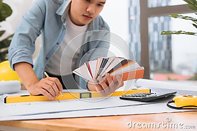 Workplace items tools for project, Architect or Engineer working on blueprint for architectural project in progress, construction Stock Photo
