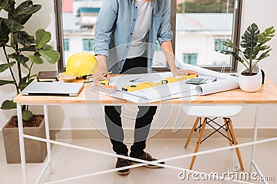 Workplace items tools for project, Architect or Engineer working on blueprint for architectural project in progress, construction Stock Photo