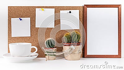 Workplace Mockup. Banner. Three white stickers, empty vertical frame, white cup, two cactus on a white background Stock Photo
