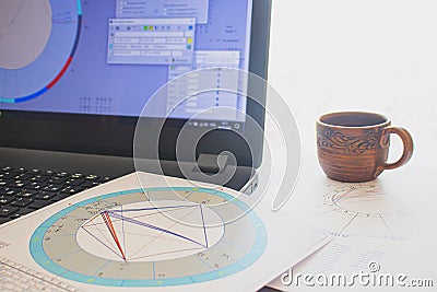 Workplace of a modern astrologer. A cup of aromatic coffee on the table Stock Photo