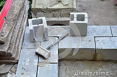 The beginning of the construction of the wall of the economic building of cinder block, one stone thick. Stock Photo