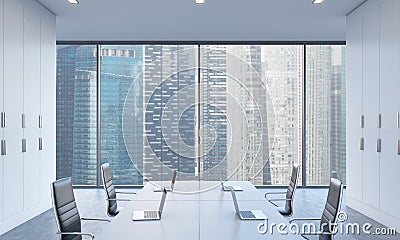 Workplaces or conference area in a bright modern open space office. White tables equipped by modern laptops and black chairs. Sing Stock Photo