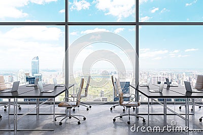 Workplaces in a modern panoramic office, New York city view from the windows. Open space. Black tables and brown leather chairs. Stock Photo