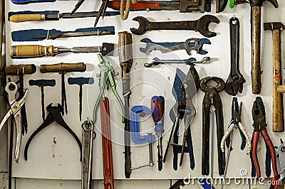 Workshop scene. Old tools shelf against a table and wall Stock Photo