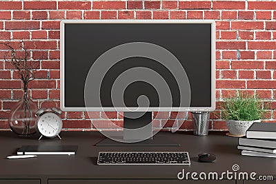 Workspace with blank computer monitor black screen mock up on the black desk near red brick wall. Stock Photo