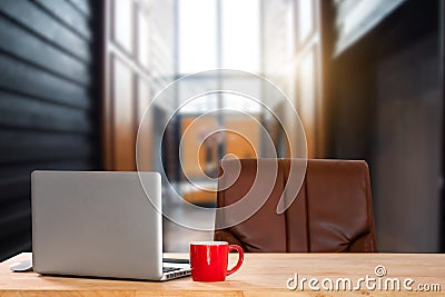 Front view of cup and computer, smartphone, and tablet on table in office Stock Photo