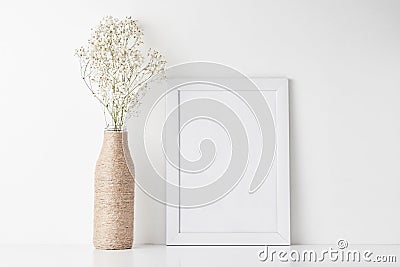 Workspace desk with empty frame and flower in vase Stock Photo