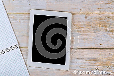 Workspace desk with paper notebook on table touch screen device with copy space background Stock Photo
