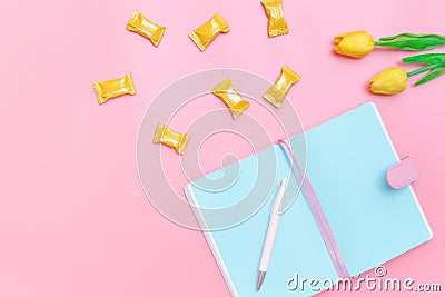 Workspace desk styled design office supplies, candy and flower on pink pastel background minimal style Stock Photo