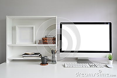 Workspace Mockup Computer on Office Desk and Books, Photo Frame and Books on Shelves Stock Photo