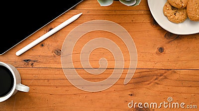 Workspace with tablet, accessories and empty space on rustic hardwood table background Stock Photo