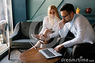 Workteam in office working together on laptop Stock Photo