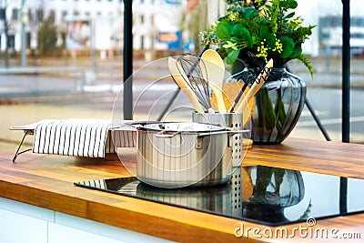 Worktop with hob and cooking equipment in front of a large window frontage Stock Photo