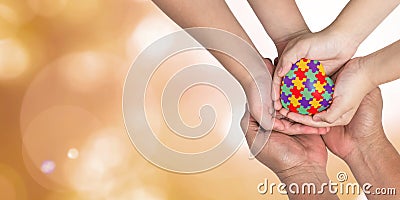 World Autism Awareness day, mental health care concept with puzzle or jigsaw pattern on heart with autistic child`s hands support Stock Photo