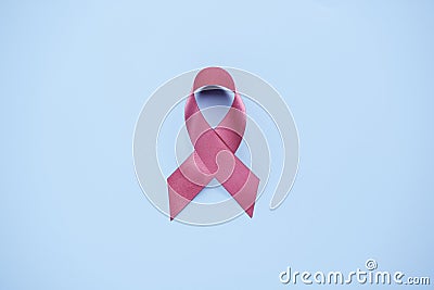 World cancer day and breast cancer day concept, Pink ribbon awareness symbol on blue background. Cancer is cause of number one Stock Photo