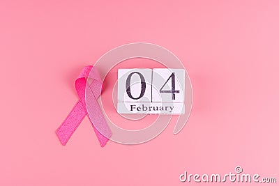 World cancer day with calendar of February 4 and Pink Ribbon supporting people living and illness. Healthcare concept Stock Photo