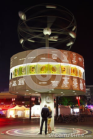 World clock in Berlin at night, couple Editorial Stock Photo