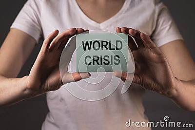 World crisis inscription on paper in female hands Stock Photo